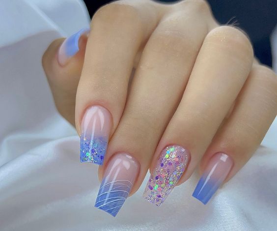 Blue and white ombre nails with holographic effect. 