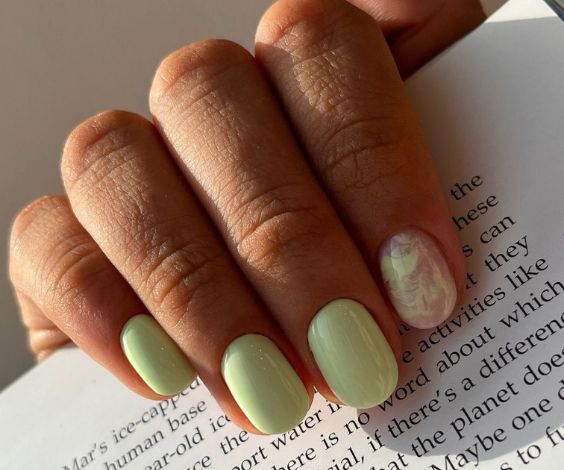 Simple sage green nails with marble nail design. 