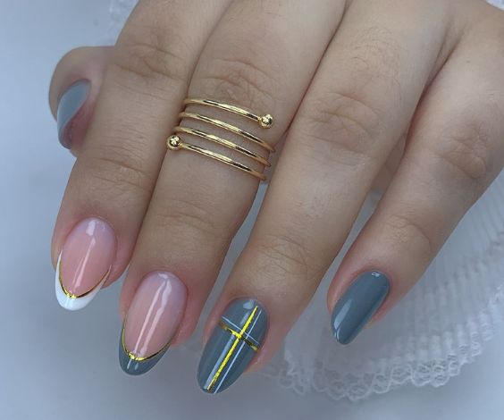 Pastel blue and white manicure with gold metallic accents. 