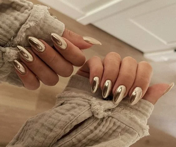 Pure metallic gold almond nails with a shiny finish for a birthday party.