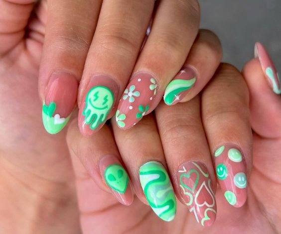 Mint green mix-and-match nail art on almond nails. 