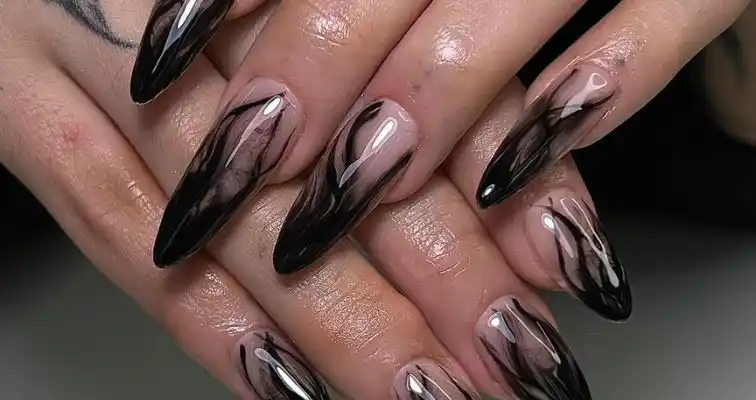 Black smokey nail art on acrylic almond nails.