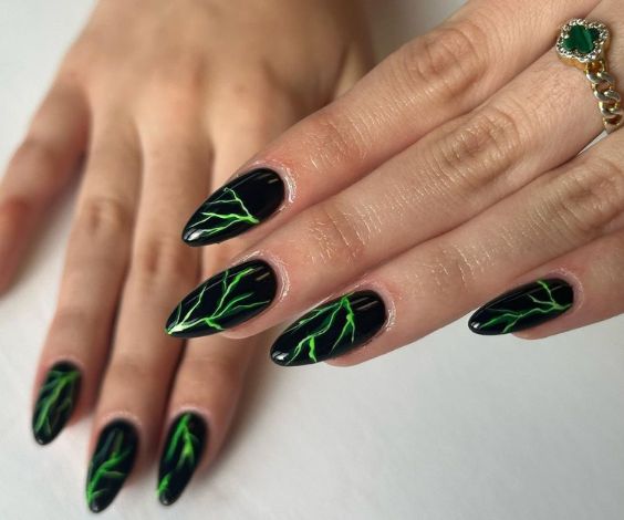 Black nails with neon green thunderlight patterns. 
