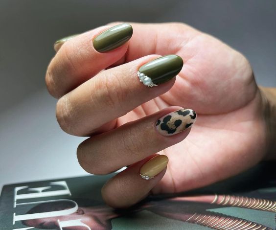 Nude and olive green nail color combination with animal print and 3D stones. 
