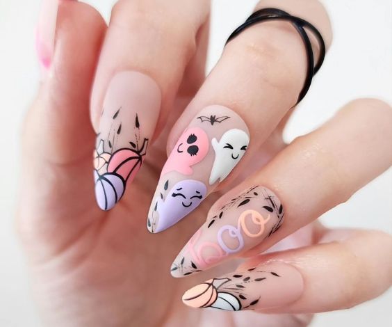 Cute Halloween nails with pastel ghosts and matte finish. 