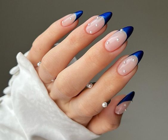 Blue almond French tips with white 3D pearls.