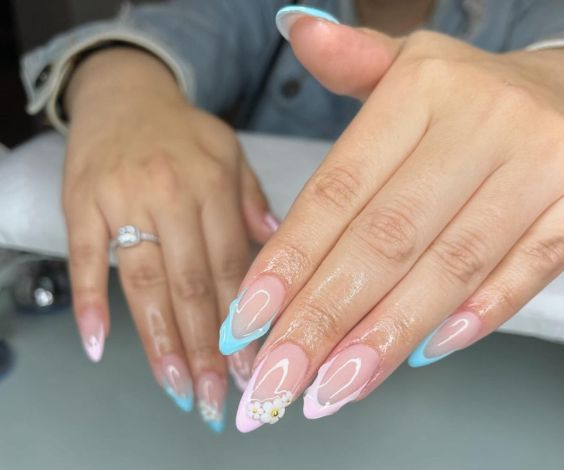 Pink and blue French tips with 3D gel and acrylic flowers. 