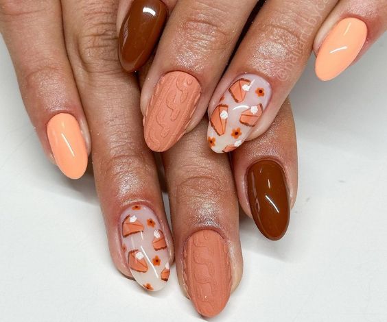 Nude nails with pumpkin and sweater nail designs