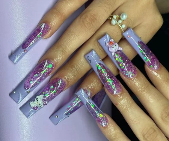 Cute purple acrylic nails with French tips, holographic glitters, and 3D nail art.