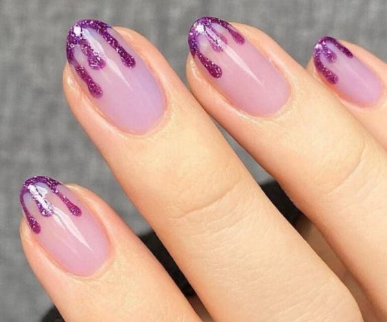 Purple dip nails with dripping art on tips. 