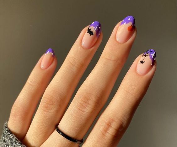 Cute purple French tips with bats and spider web design. 