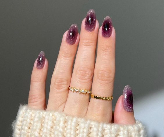 Wine red aura nails with a glossy finish. 