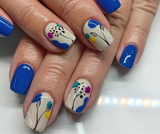 Abstract nail art with royal blue and white nail colors. 