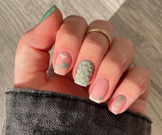 Textured heart nail art with sage green nail color. 