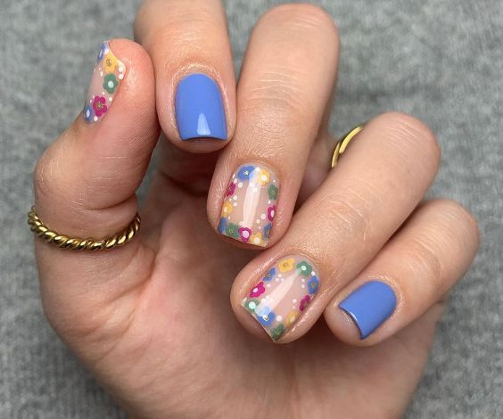 Cute spring flower nail art with blue nail color. 