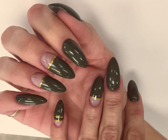 Almond nails with olive green nail color and gold stripes. 
