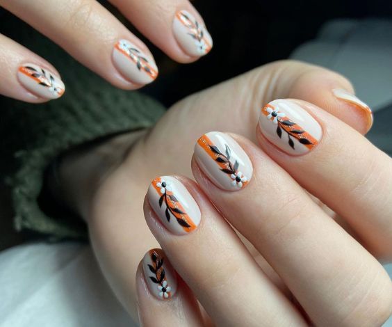 White round nails with leaves and stripes patterns