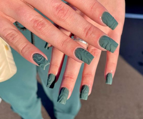 Matte square nails with green textured nail art. 
