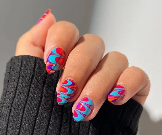 Easy water marble nail design with blue, red, and orange nail colors.