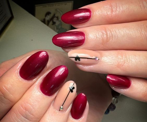 Wine red nail color and heart nail design. 