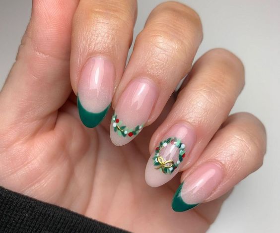 Cute Christmas nails with forest green nail color and wreath designs. 