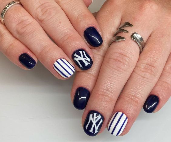 New York Yankees nail art with navy blue and white nail colors. 