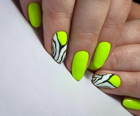 Neon green nails with zebra print nail art. 
