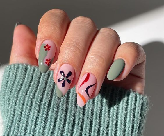 Sage green nails with groovy patterns