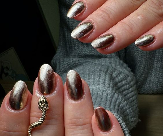 Rust metallic nails with a warm, shimmery finish