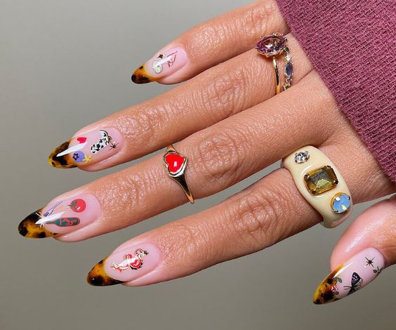 Animal print French tip nails with western-themed stickers